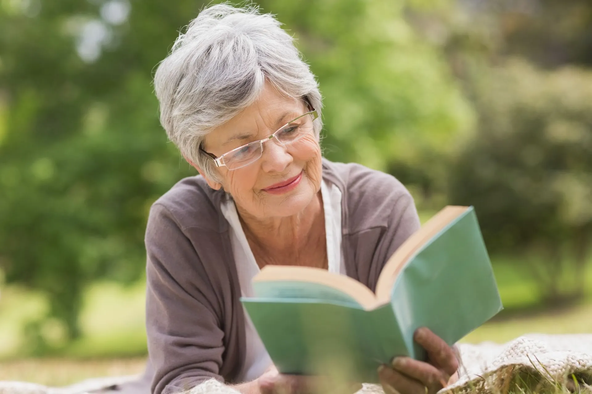 The Birches on Maple - Senior Woman Holding a Book Reading