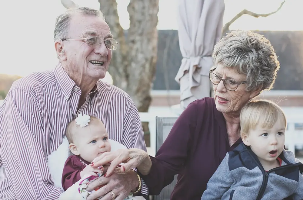 The Birches on Maple - Grandparents Holding Their Grandchildren