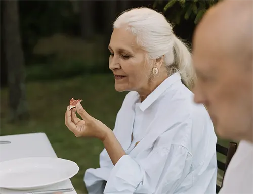 The Birches on Maple - Senior Lady Eating A Fruit