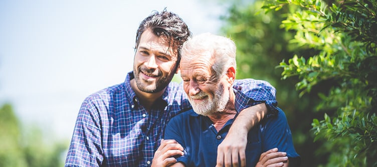 man with his arm around his elder father