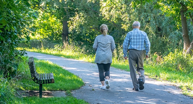 couple strolling down a path