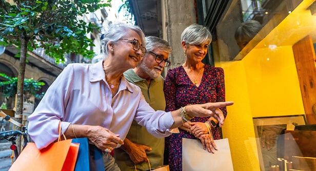 3 friends on a sidewalk window shopping